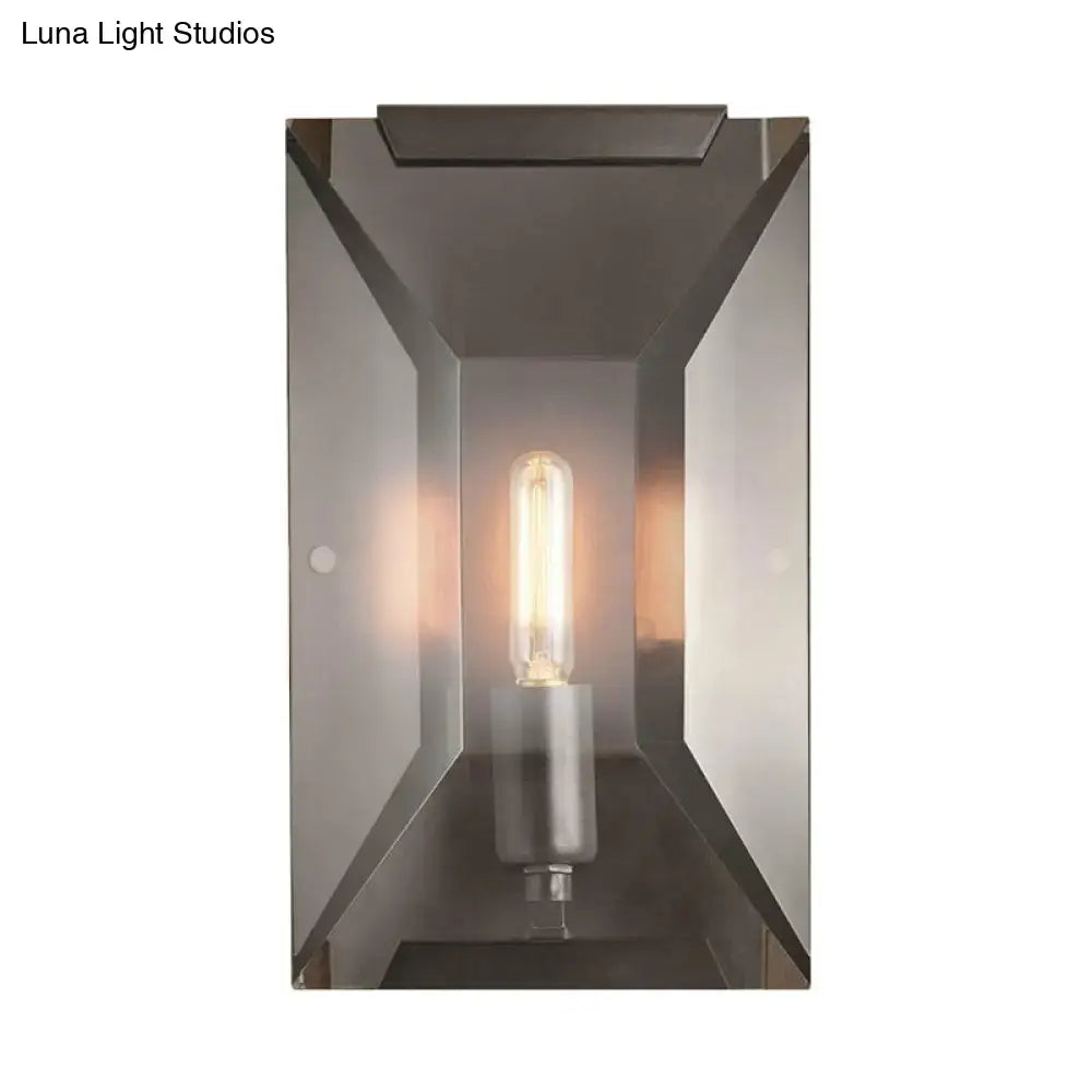 Black metal oblong wall sconce with clear glass enclosure and Edison filament bulb on Tampa Home & Garden Store