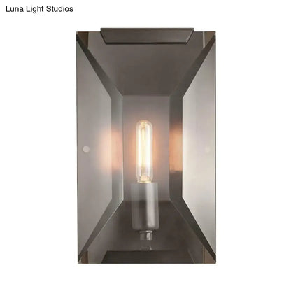 Black metal oblong wall sconce with clear glass enclosure and Edison filament bulb on Tampa Home & Garden Store