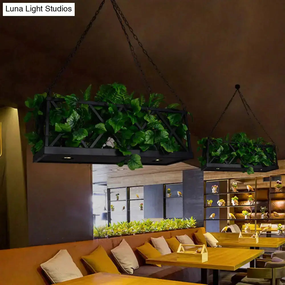 Industrial black hanging island lights with two LED-lit planters and greenery on Tampa Home & Garden Store