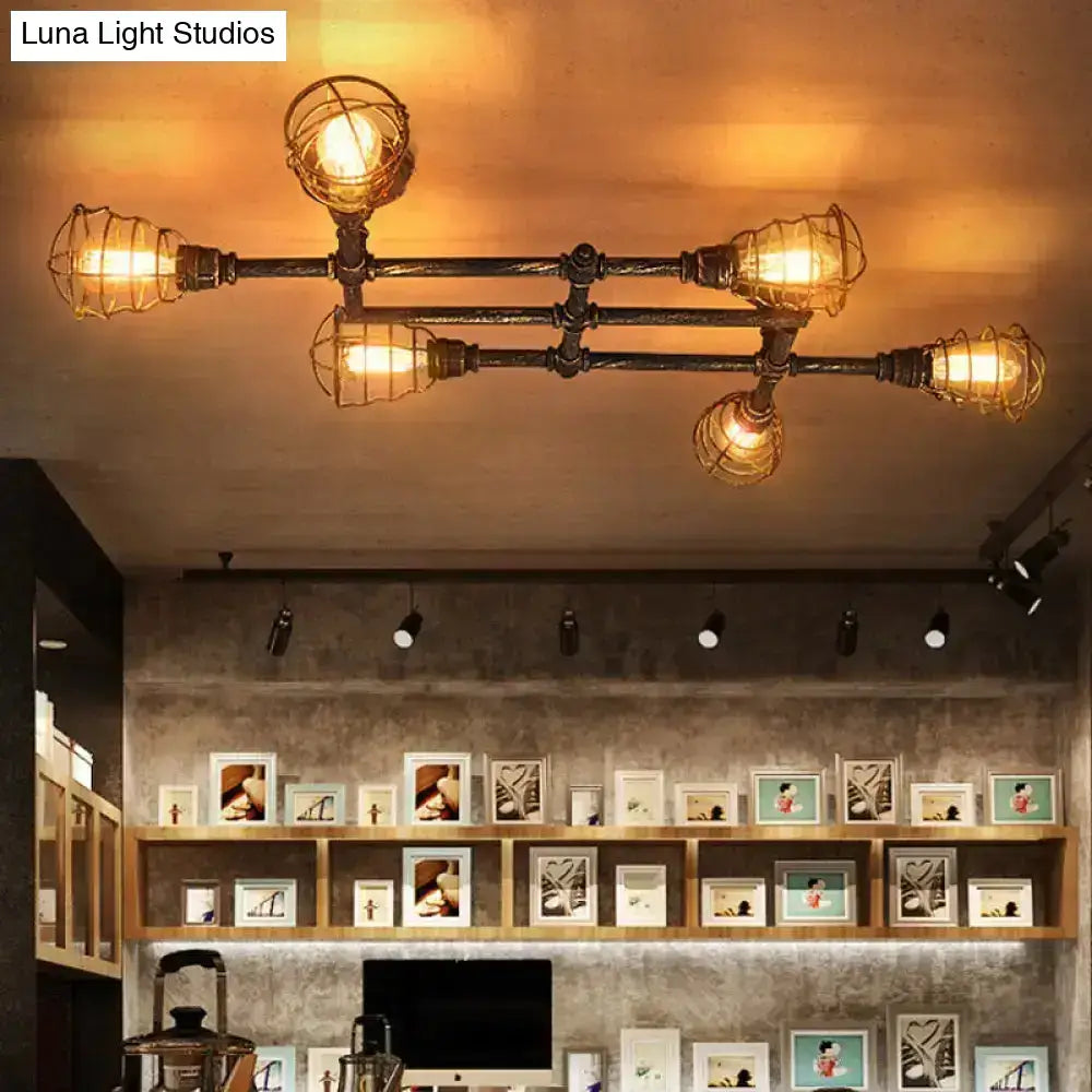 Brass piping ceiling light fixture with five industrial cage bulbs and warm glow by Decorbites on Tampa Home & Garden Store