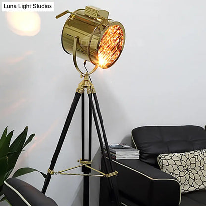 Tripod metal floor lamp with brass-gold spotlight head and black legs by Decorbites on Tampa Home & Garden Store