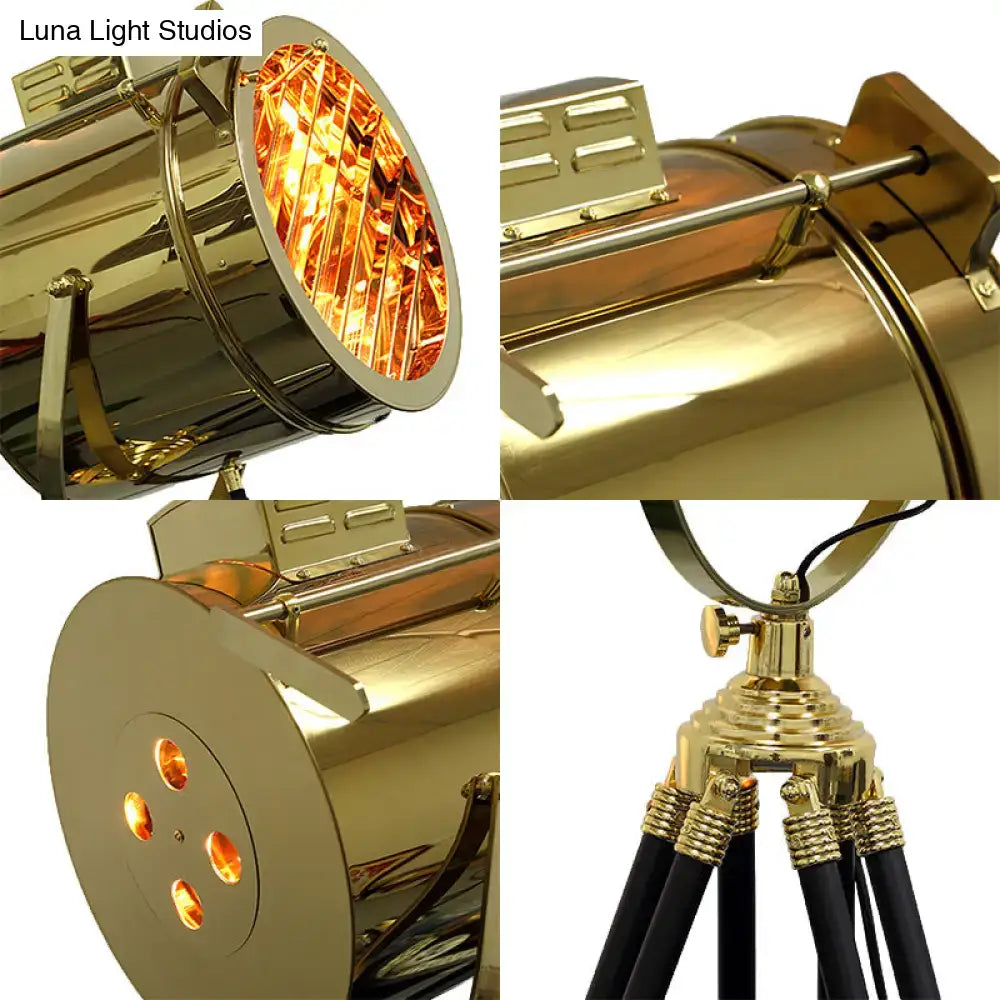Tripod metal floor lamp by Decorbites in brass gold finish with black legs on Tampa Home & Garden Store