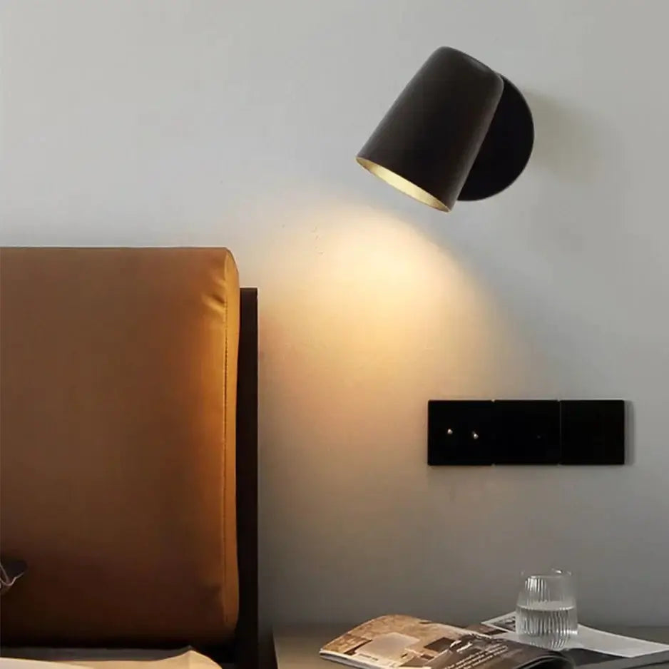 Nickel LED Wall Sconce with black cone shade, wall-mounted by Decorbites casting warm glow on Tampa Home & Garden Store