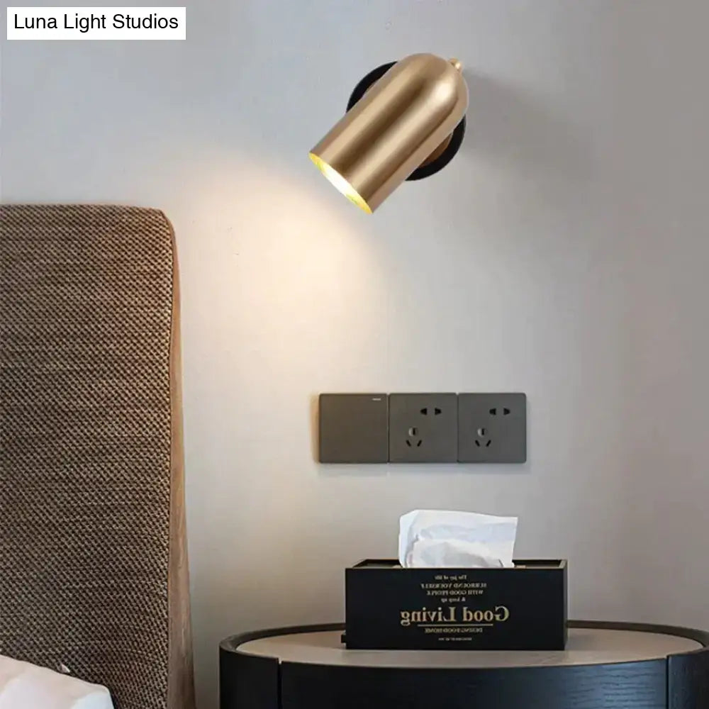 Decorbites nickel LED wall sconce mounted above bedside table with tissue box in a bedroom on Tampa Home & Garden Store