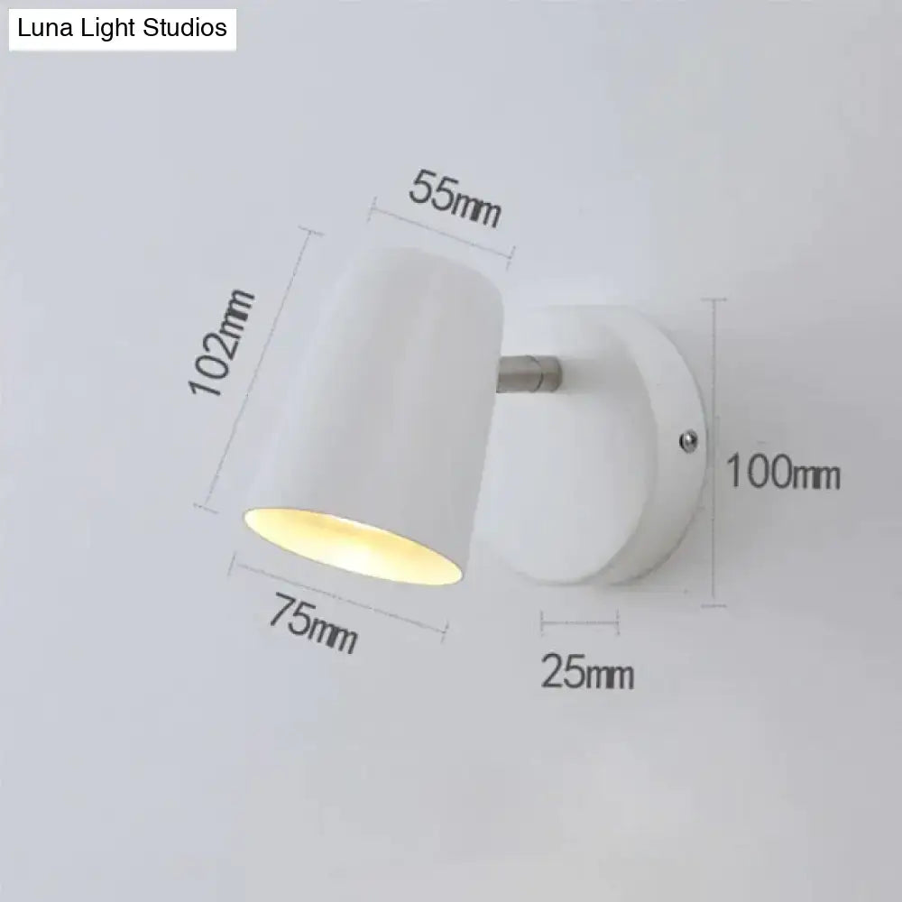 Nickel LED Wall Sconce with white cylindrical shade on round wall mount; warm LED light on Tampa Home & Garden Store