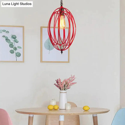 Industrial red oval cage pendant light by Decorbites with exposed bulb over round dining table on Tampa Home & Garden Store