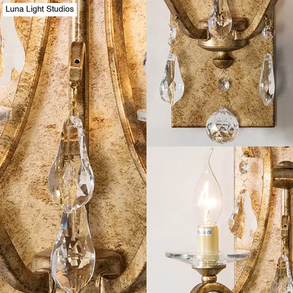Rust iron crystal teardrop wall sconce with hanging prisms in a gold finish by Decorbites on Tampa Home & Garden Store