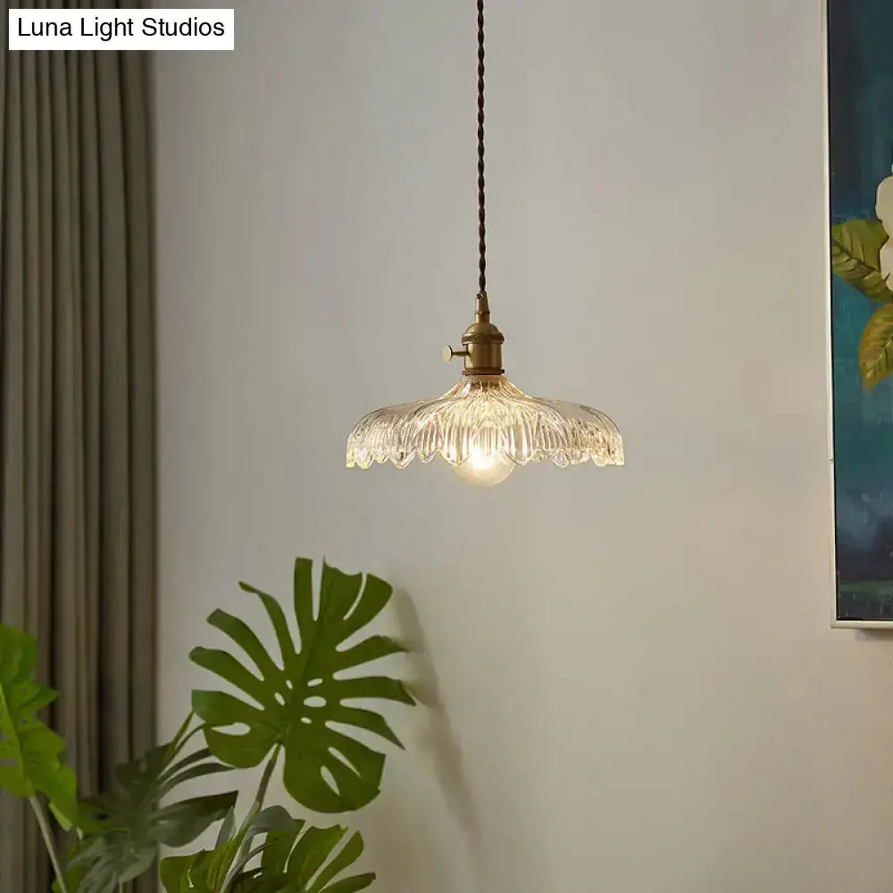 Industrial scalloped edge clear glass pendant light with brass fitting and twisted cord on Tampa Home & Garden Store