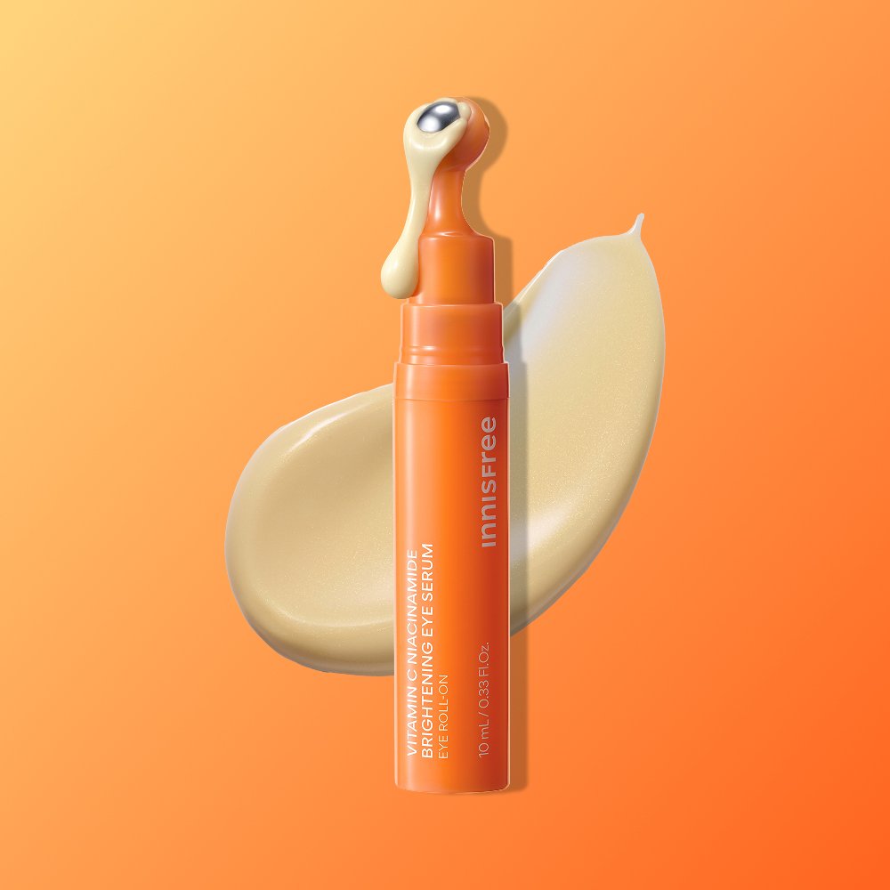 innisfree Vitamin C Niacinamide Eye Serum orange pump bottle, 10 mL on orange gradient backdrop on Tampa Home & Garden Store