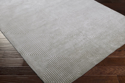 Ivel Carpet rug by Boutique Rugs with light gray geometric diamond pattern on a wood floor on Tampa Home & Garden Store
