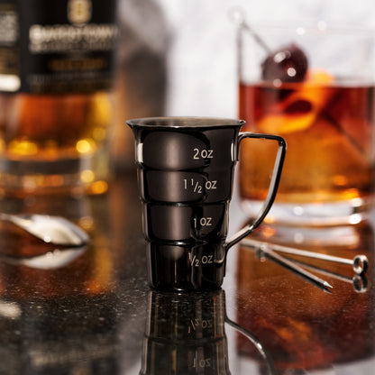 Gunmetal Viski jigger with stepped dual bowls and engraved 2 oz and 1/2 oz marks on black metal on Tampa Home & Garden Store