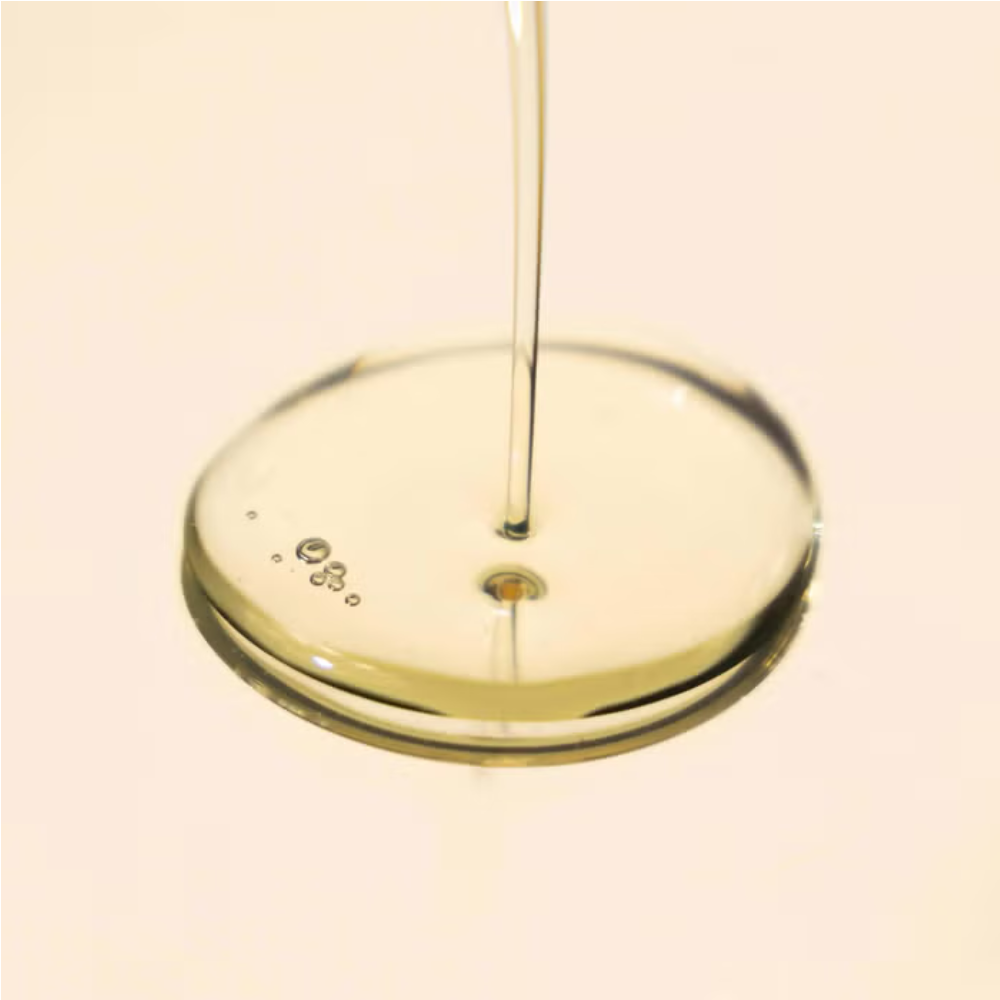 Elemis Japanese Camellia Body Oil Blend being poured into a clear glass dish, pale golden oil on Tampa Home & Garden Store