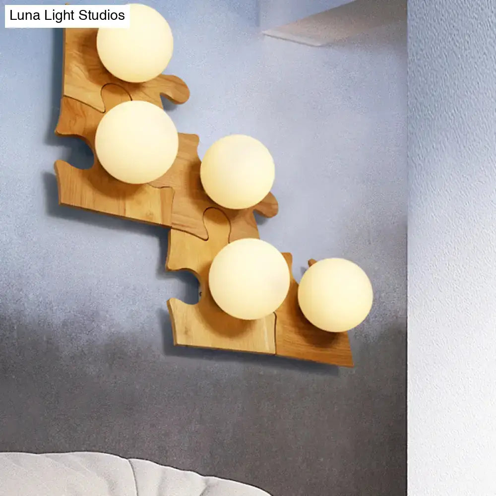 Wooden puzzle wall light by Decorbites with five warm globe bulbs on natural wood puzzle panels on Tampa Home & Garden Store