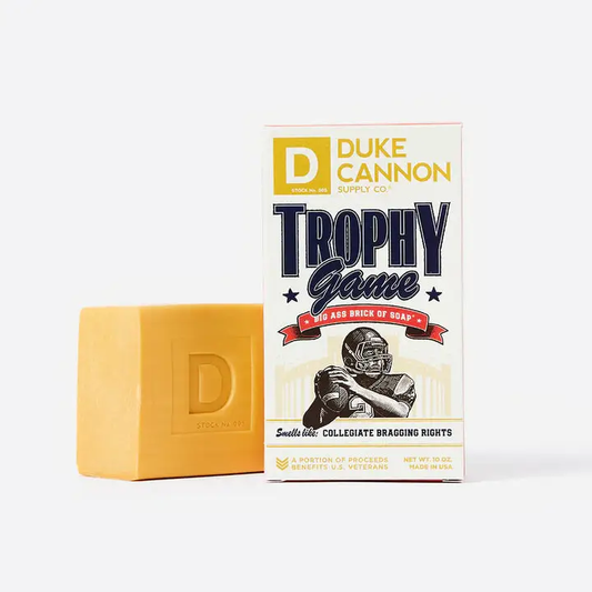 Duke Cannon Trophy Game smoked leather amber soap bar beside its Trophy Game packaging on Tampa Home & Garden Store