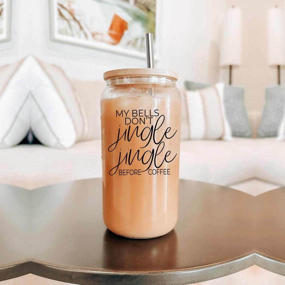 Jingle Jingle 17oz glass tumbler with wood lid and metal straw filled with iced coffee on Tampa Home & Garden Store