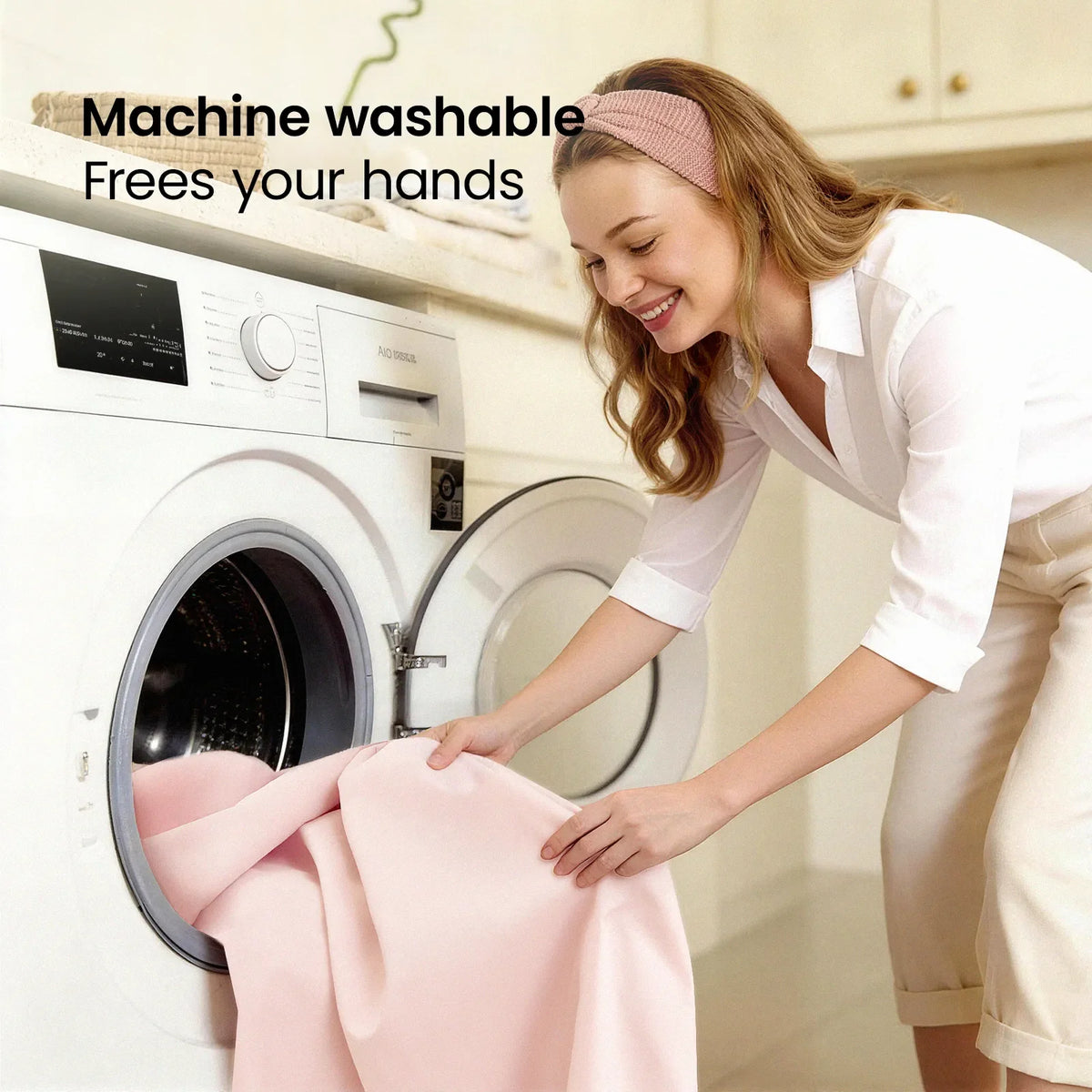 Woman loads a pink blanket into a front-loading washing machine in a bright laundry room on Tampa Home & Garden Store