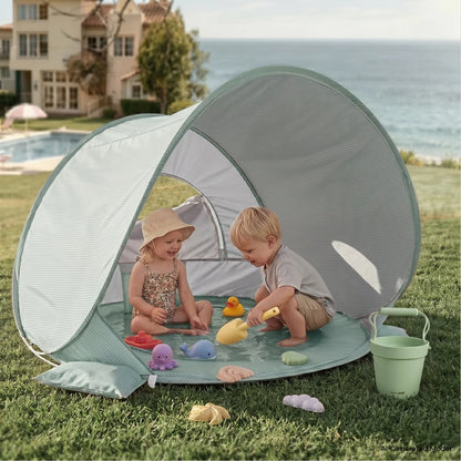 Tiny Land 3-in-1 Baby Beach Tent in light green striped fabric with two kids playing with sand toys near the water on Tampa Home & Garden Store