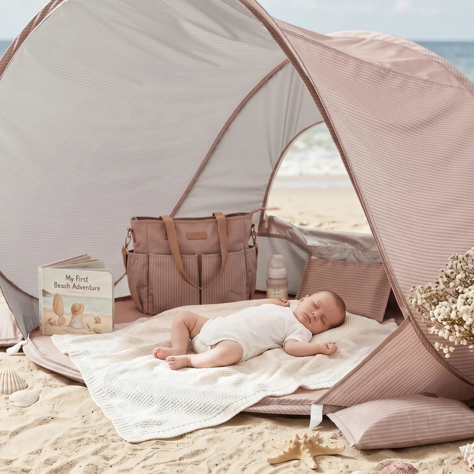 Tiny Land 3-in-1 Baby Beach Tent beige canopy with baby on blanket beside tote and book on sand on Tampa Home & Garden Store