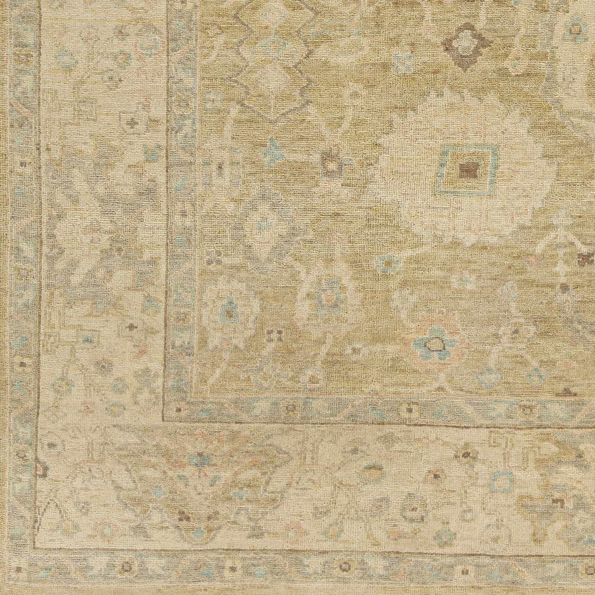 Karalee Wool Area Rug by Boutique Rugs in beige with faded medallion and pale blue accents on Tampa Home & Garden Store