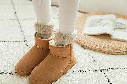 Stevvex crew socks with plush fleece cuff peeking from tan ankle boots for cozy winter look on Tampa Home & Garden Store