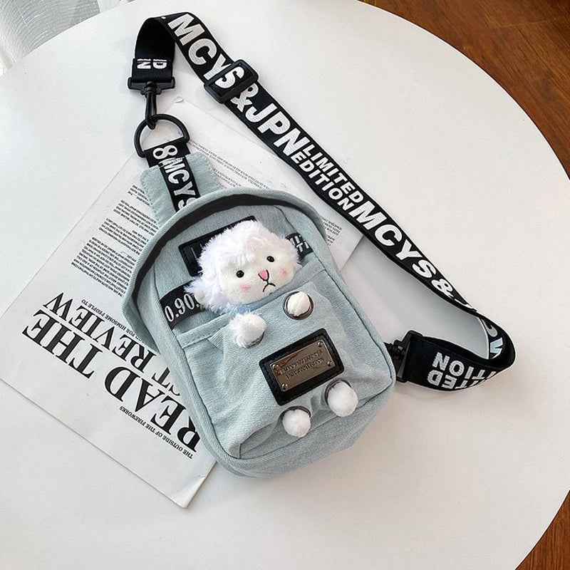 Shaketea denim sling bag with a plush white sheep charm and adjustable strap on Tampa Home & Garden Store