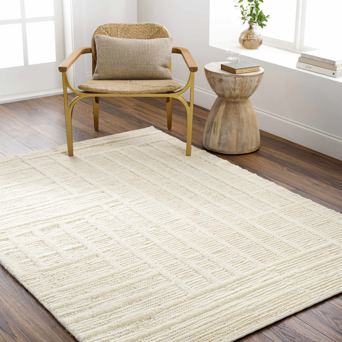 Kelburn Area Rug cream textured weave by Boutique Rugs on hardwood floor beside chair on Tampa Home & Garden Store