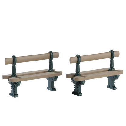 Two brown wooden double-seated village benches with dark green metal supports for village use on Tampa Home & Garden Store