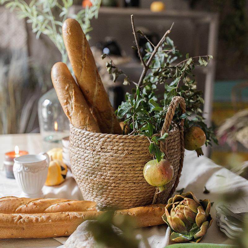 RusticReach khaki brown straw basket with handles containing two baguettes and greenery on Tampa Home & Garden Store