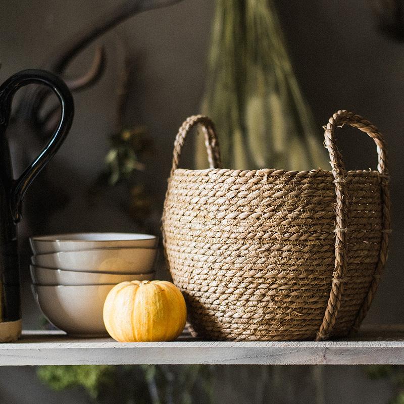 Khaki brown straw basket with handles by RusticReach on shelf with bowls and pumpkin on Tampa Home & Garden Store