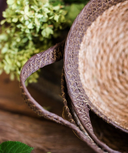 Khaki brown straw basket with handles, close-up of braided weave RusticReach on Tampa Home & Garden Store
