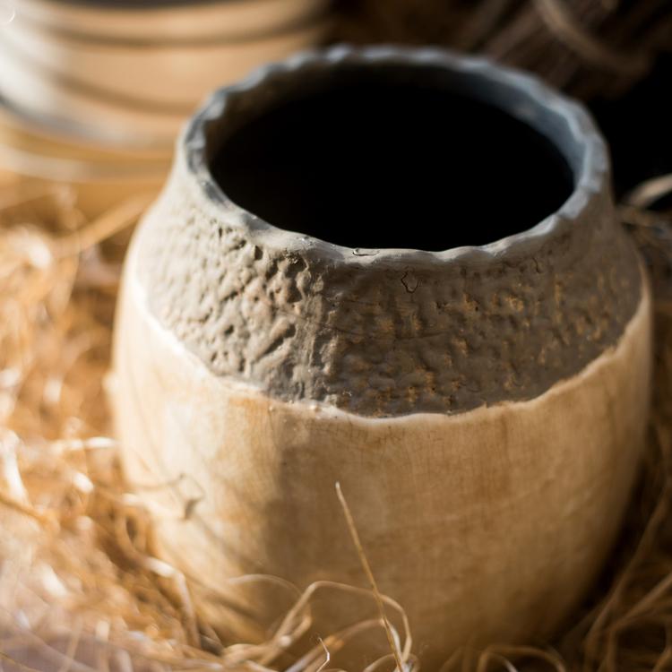 Khaki coarse pottery jar with a textured, stone-colored upper half and smooth base on Tampa Home & Garden Store