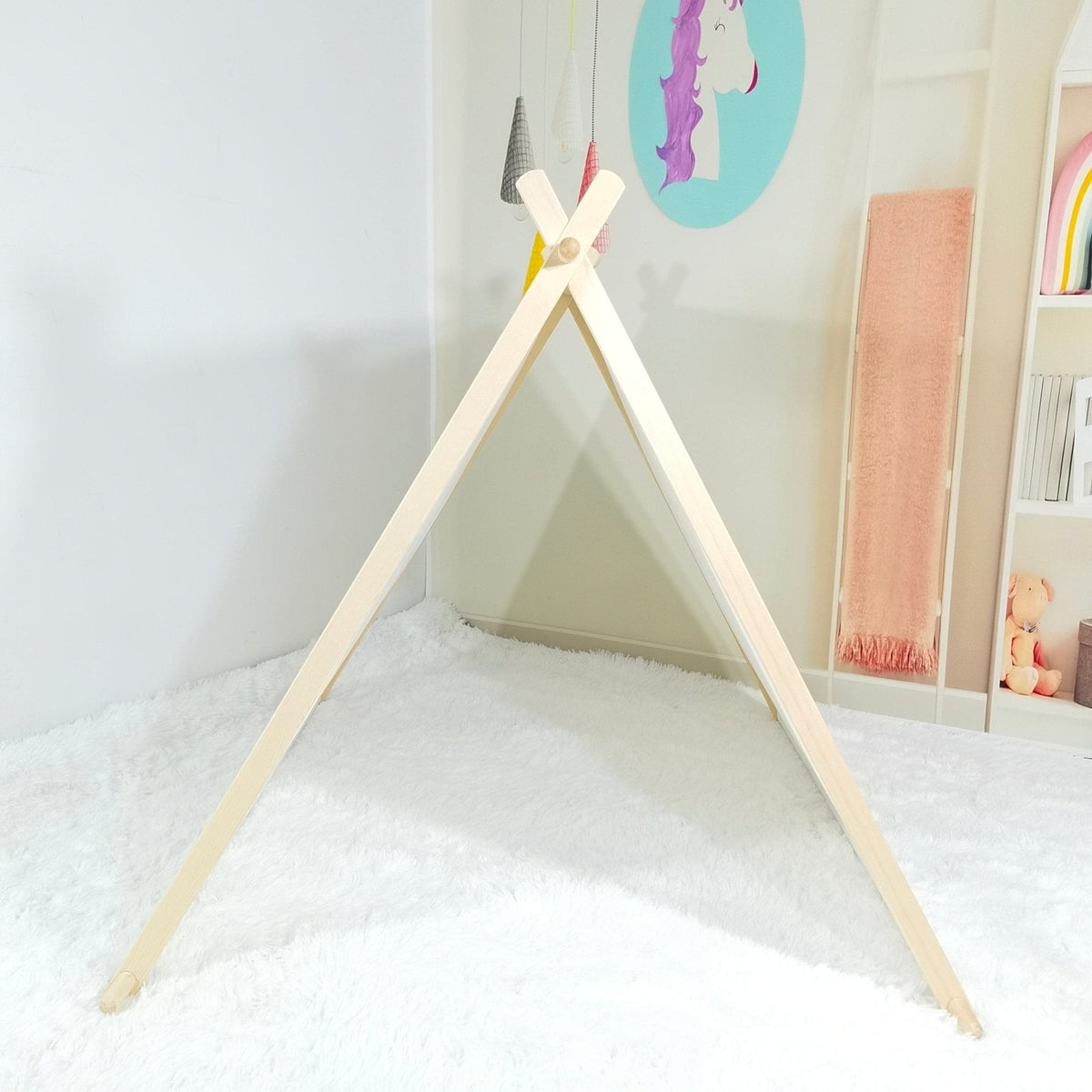 Kids A-frame sleepover tent in light wood with fluffy white rug and pastel unicorn wall art on Tampa Home & Garden Store