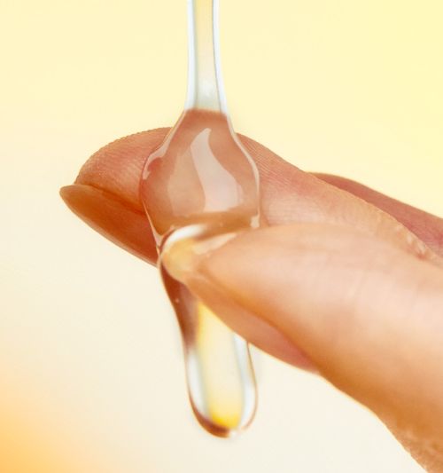 Shampoo LADOR Perfumed Hair Shampoo 530ml drop held by fingertips showing amber liquid on Tampa Home & Garden Store