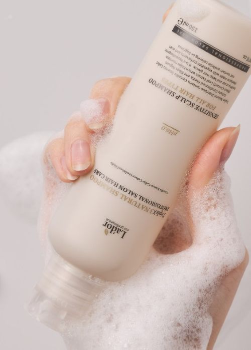 LADOR Triple X3 Natural Shampoo 530ml white bottle being foamed in hands with bubbles on Tampa Home & Garden Store
