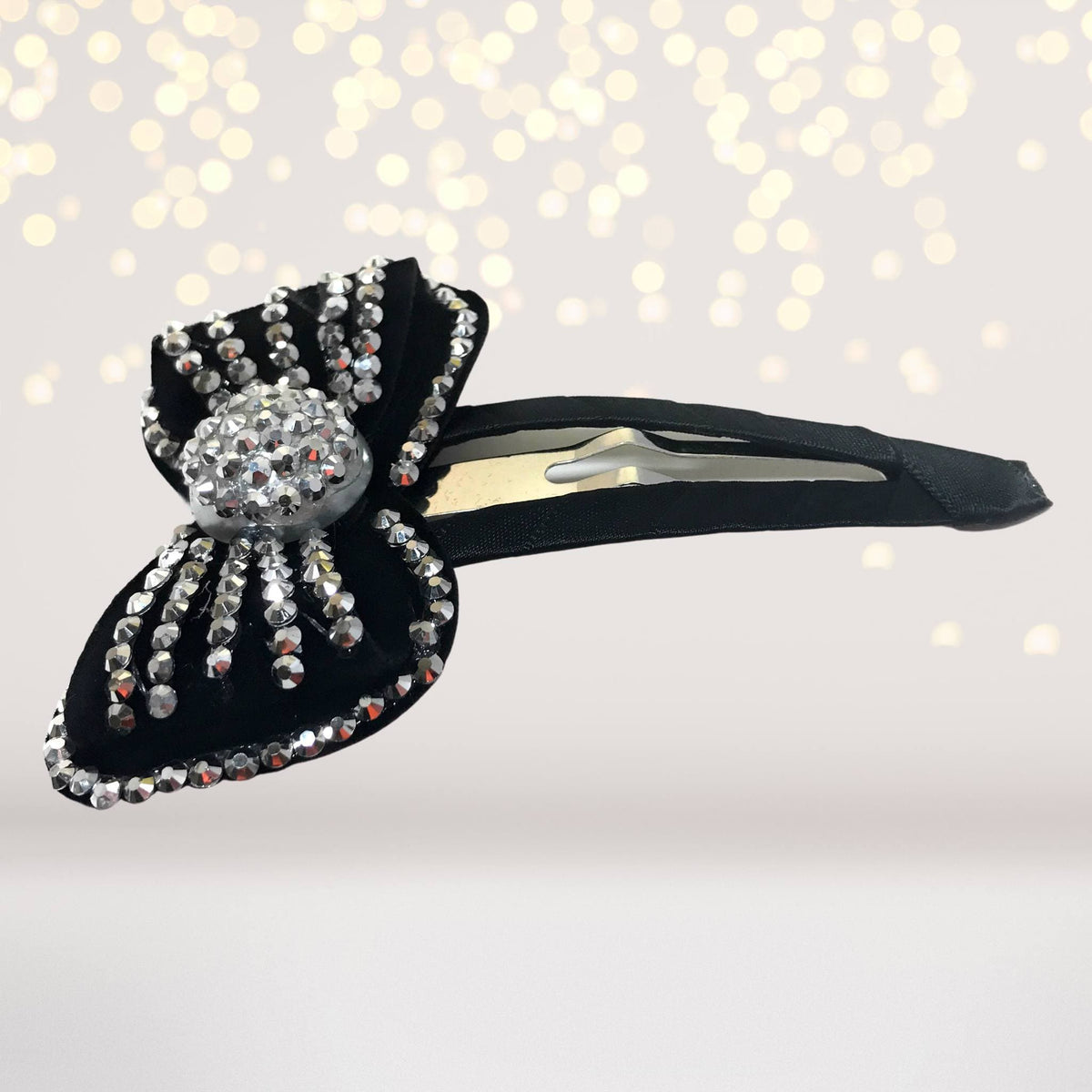 Large bling bow snappy hair clip with black base and rhinestone embellishments on Tampa Home & Garden Store