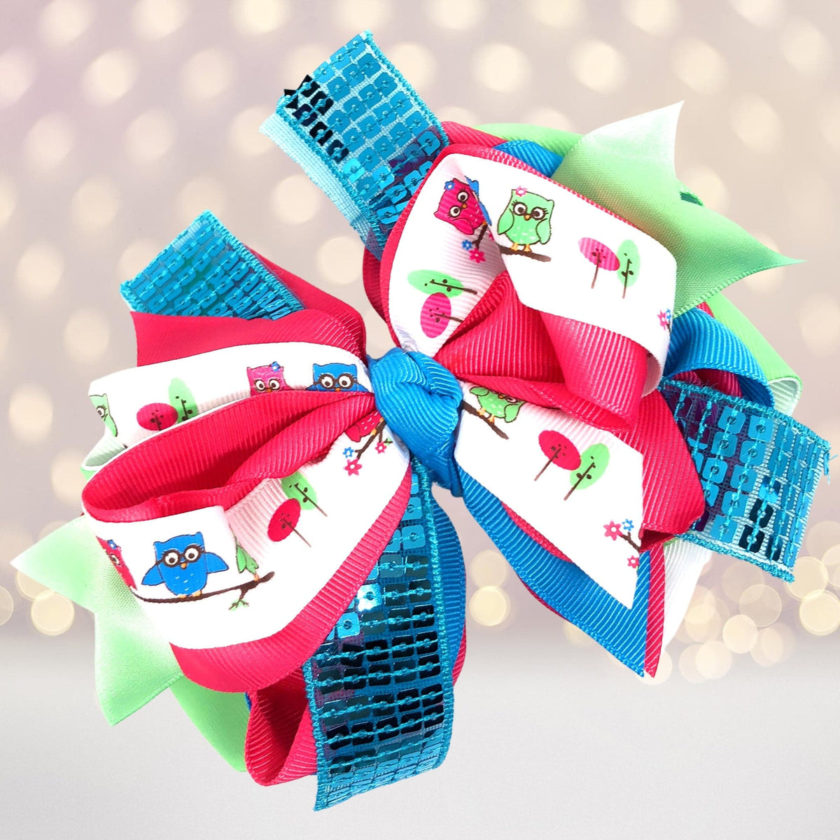 Large sequin hair bow with turquoise sequins, pink satin loops, and white owl-print accents on Tampa Home & Garden Store