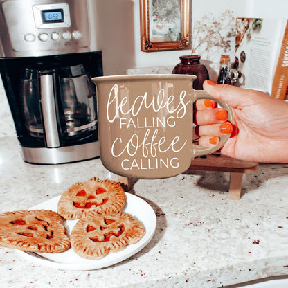 Leaves Falling coffee mug by Gia Roma in taupe ceramic held in a kitchen on Tampa Home & Garden Store