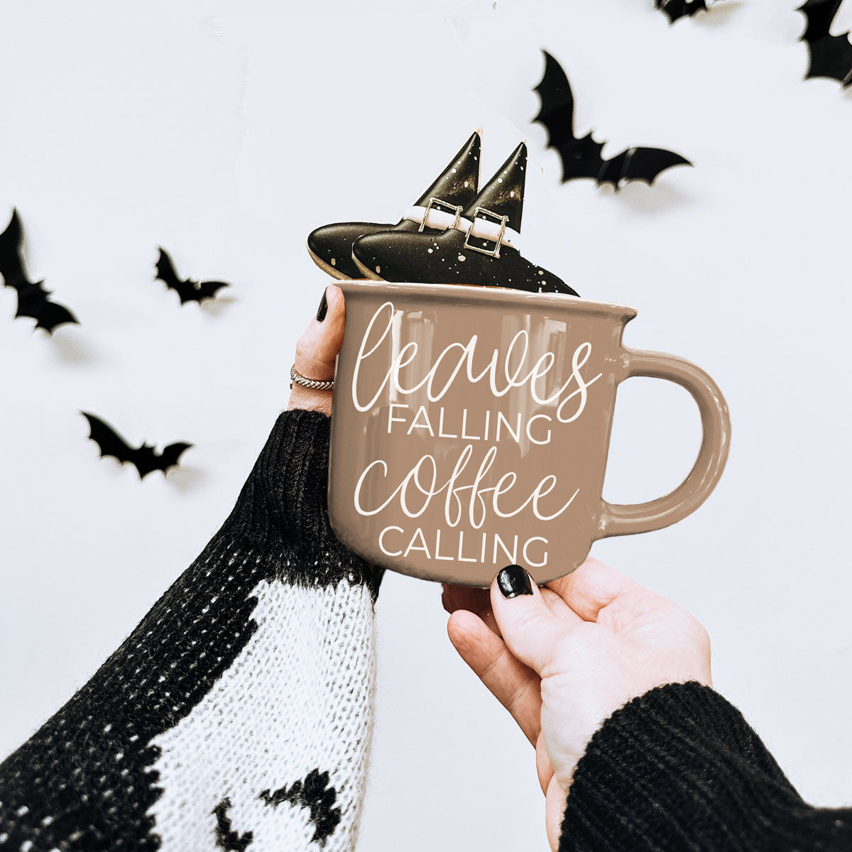 Leaves Falling mug by Gia Roma; tan ceramic with white script, two hats on rim on Tampa Home & Garden Store