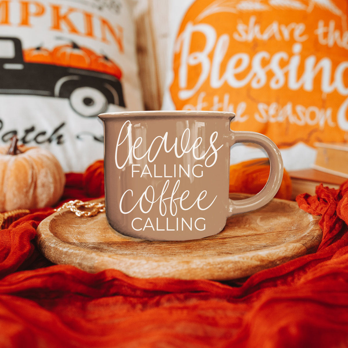 Leaves Falling coffee mug in taupe with white script on a wooden tray among pumpkins on Tampa Home & Garden Store