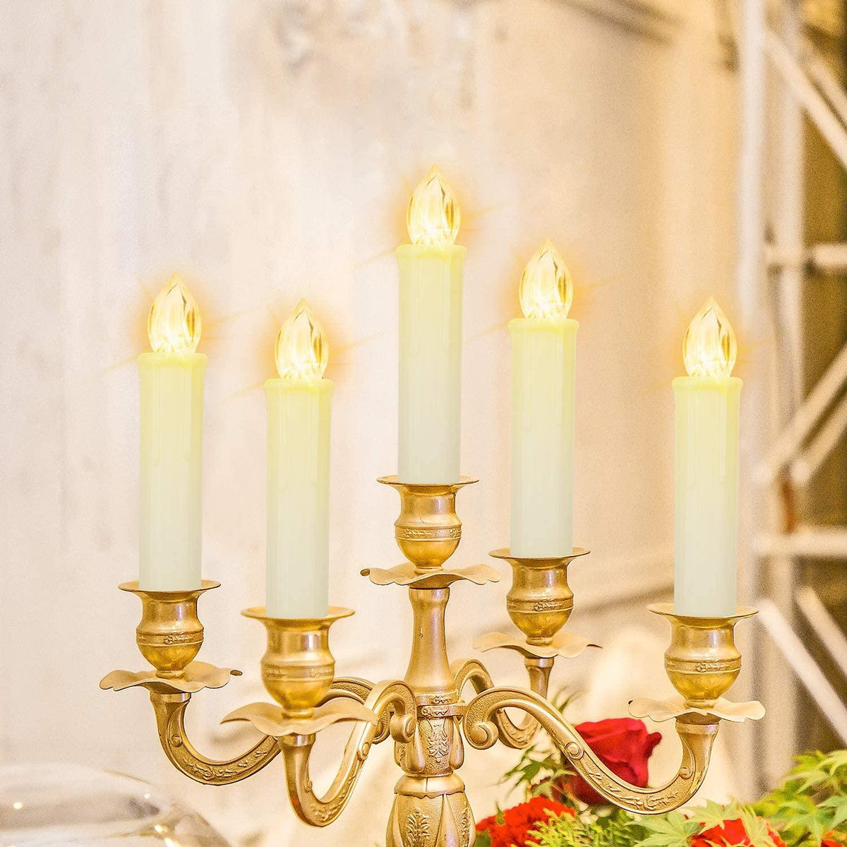 Flameless LED taper candles on a brass chandelier, five warm-white candles glow on Tampa Home & Garden Store