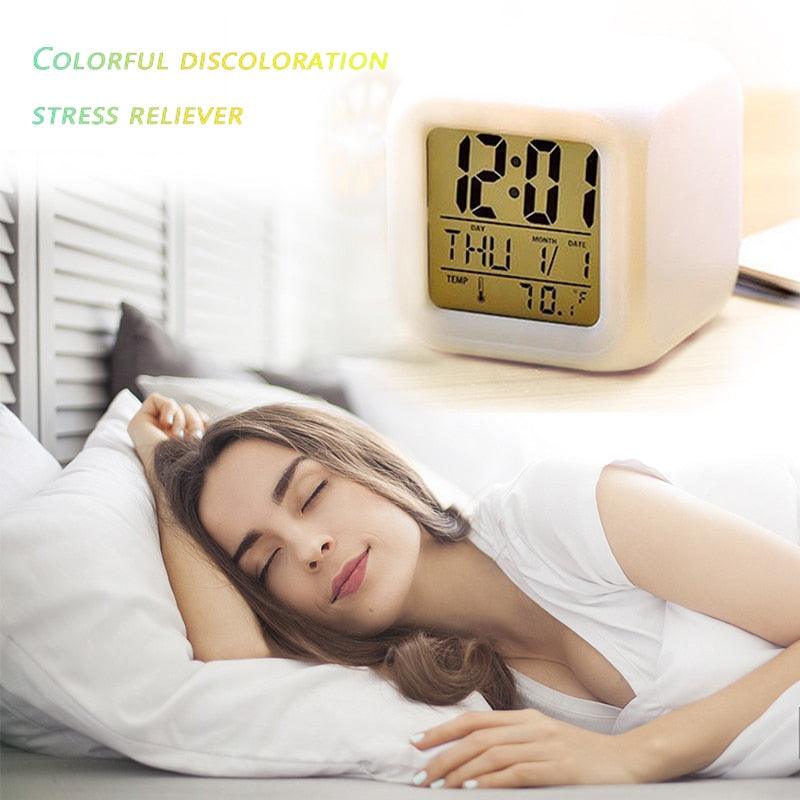 Stevvex white cube LED alarm clock with LCD time/date display on a desk beside a sleeping woman on Tampa Home & Garden Store