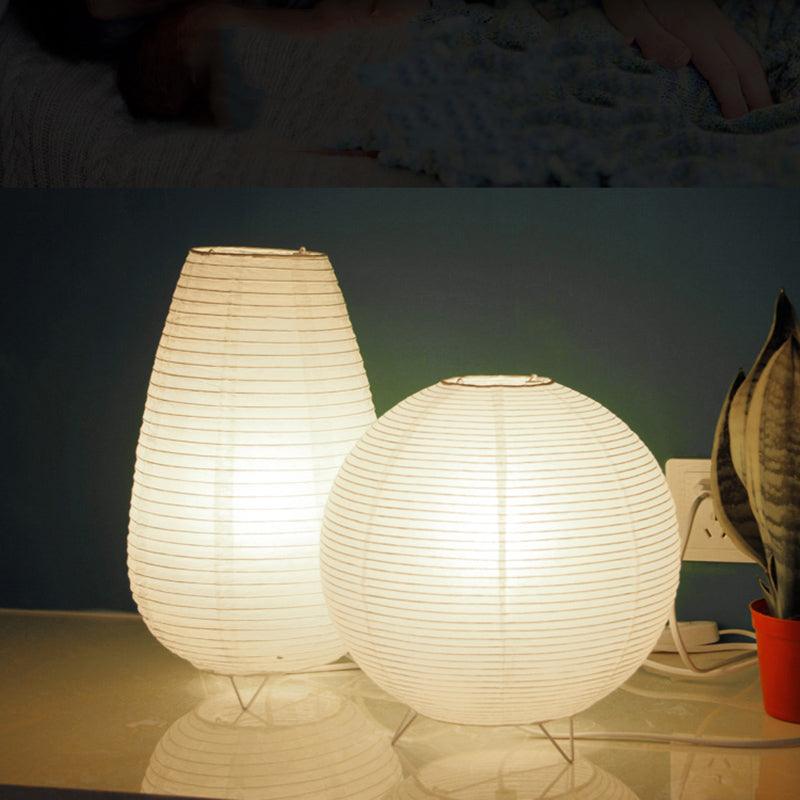 Stevvex LED paper lantern desk lamps, two white lanterns on metal tripod bases glow on a glass surface on Tampa Home & Garden Store
