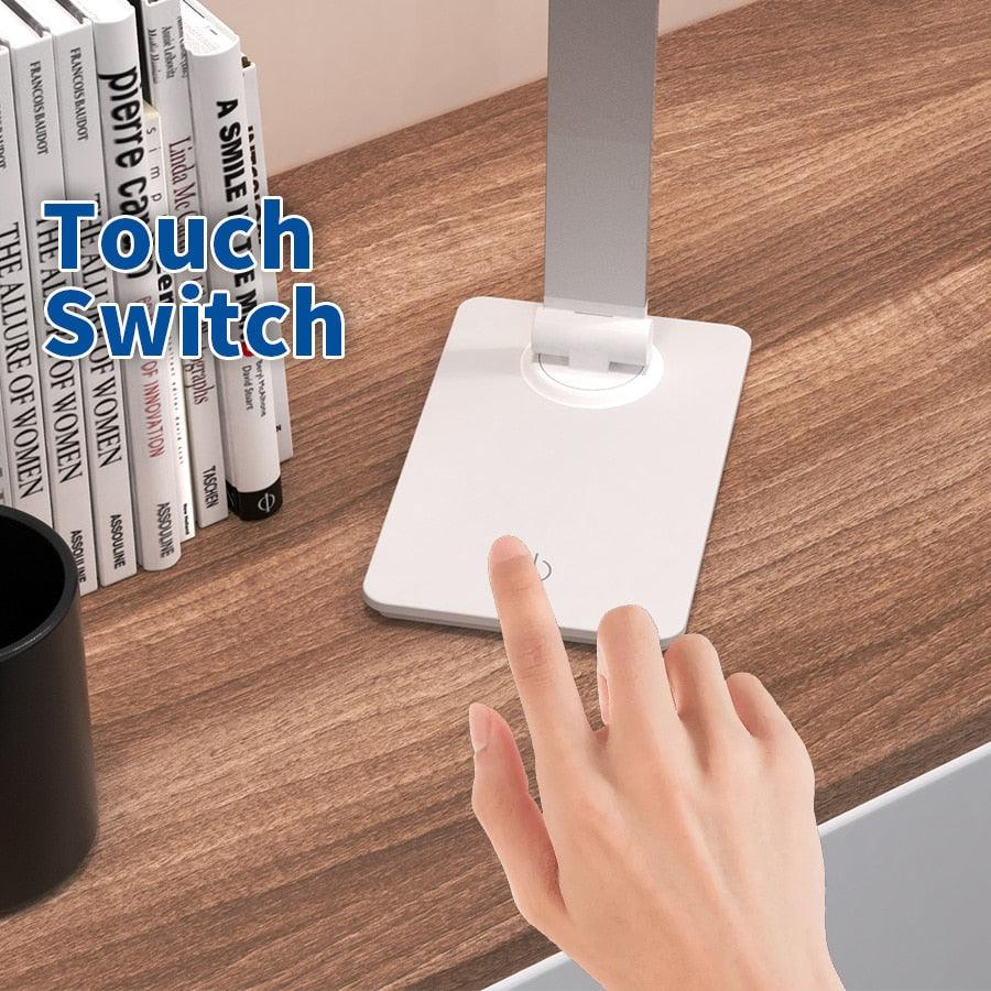 LED desk lamp Stevvex white with foldable rotatable arm and touch switch on a wood desk on Tampa Home & Garden Store