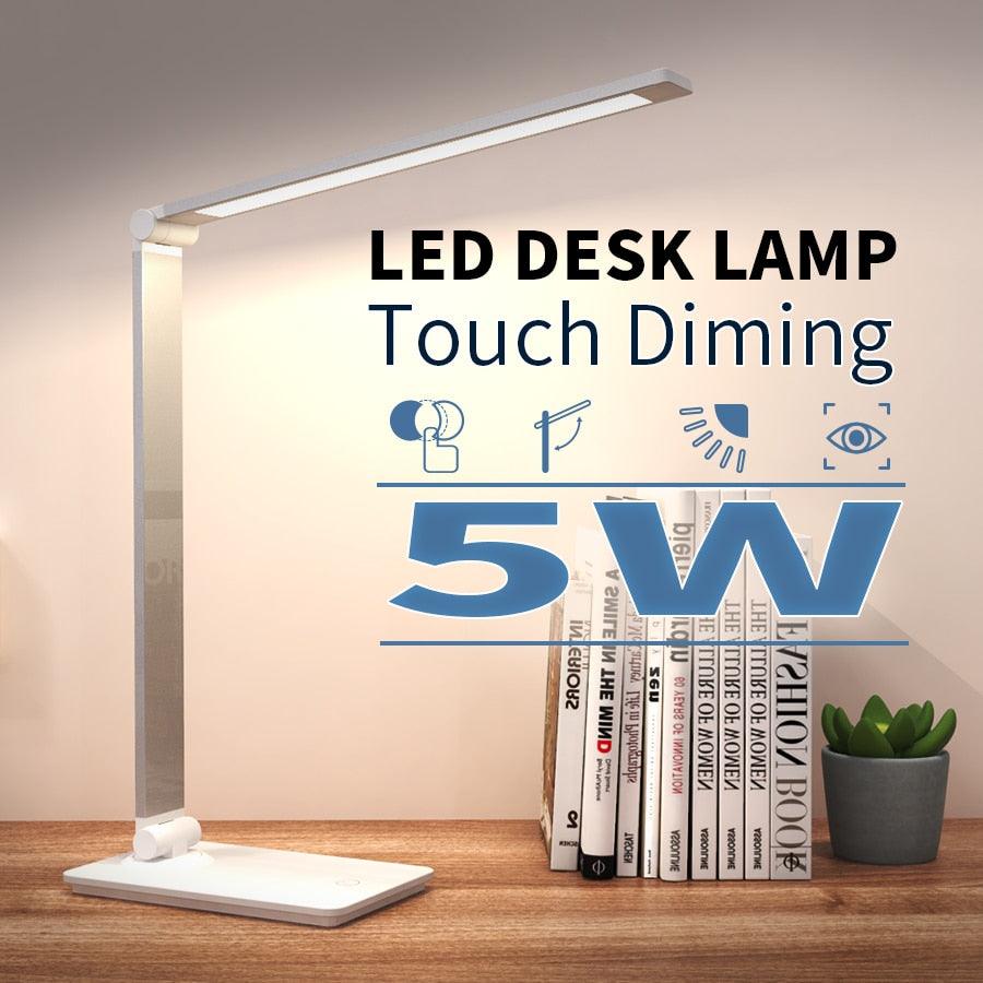 LED desk lamp with foldable adjustable arm, touch dimming, white base on a wooden desk on Tampa Home & Garden Store