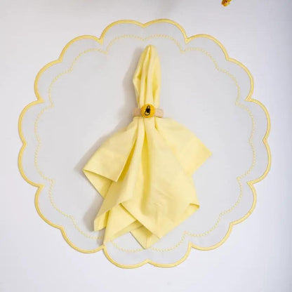 Handwoven lemon napkin ring with raffia detail around a yellow napkin by Talah Home on Tampa Home & Garden Store
