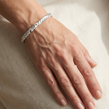 Flowers by Orly Stackable Bangle white bracelet with black floral print on wrist on Tampa Home & Garden Store