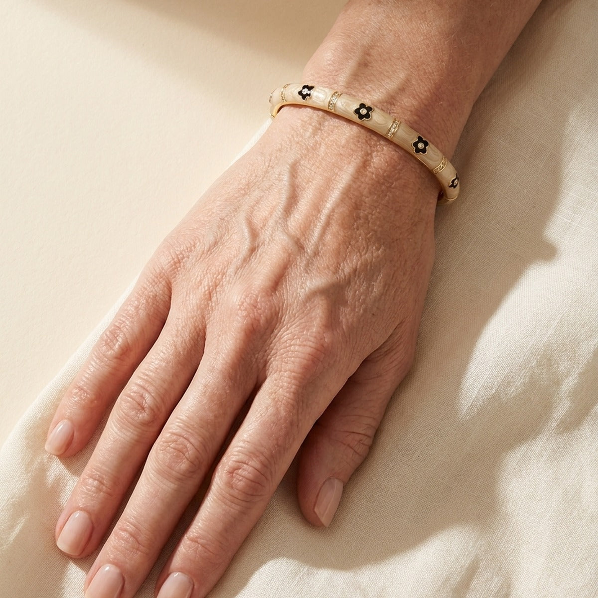 Daisy Love Stackable Bangle Contrast Flower beige with black flower charms and gold accents on Tampa Home & Garden Store