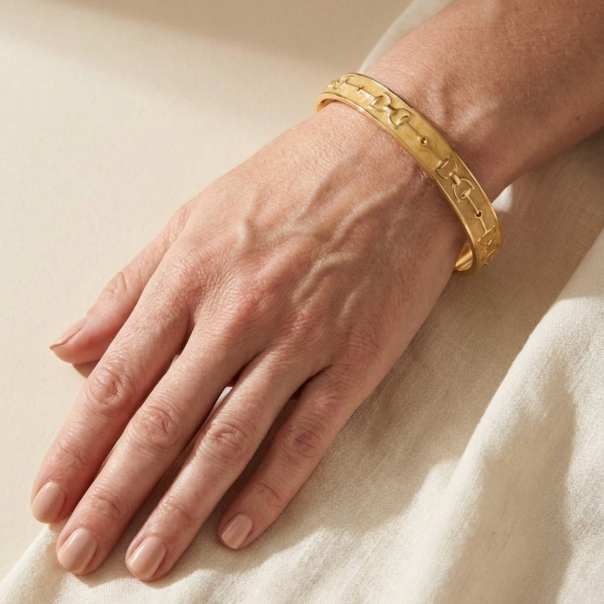 Equestrian Stirrup Bangle champagne gold-tone slip-on bracelet by Lauren G Adams on wrist on Tampa Home & Garden Store