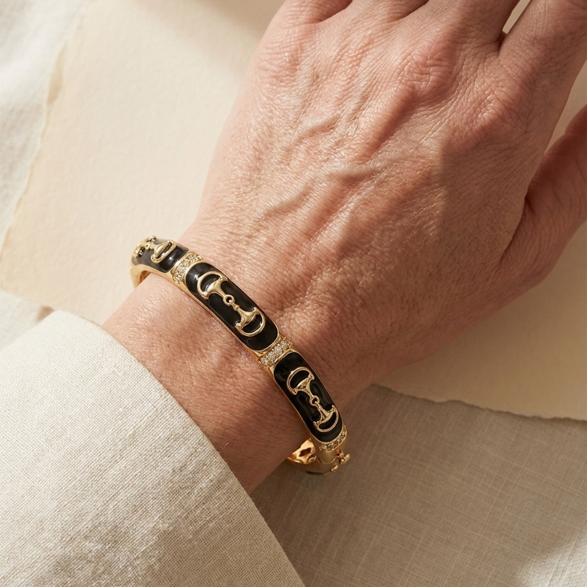 Equestrian Bangle Black Snaffle gold-tone bracelet with black enamel panels and crystal accents on Tampa Home & Garden Store