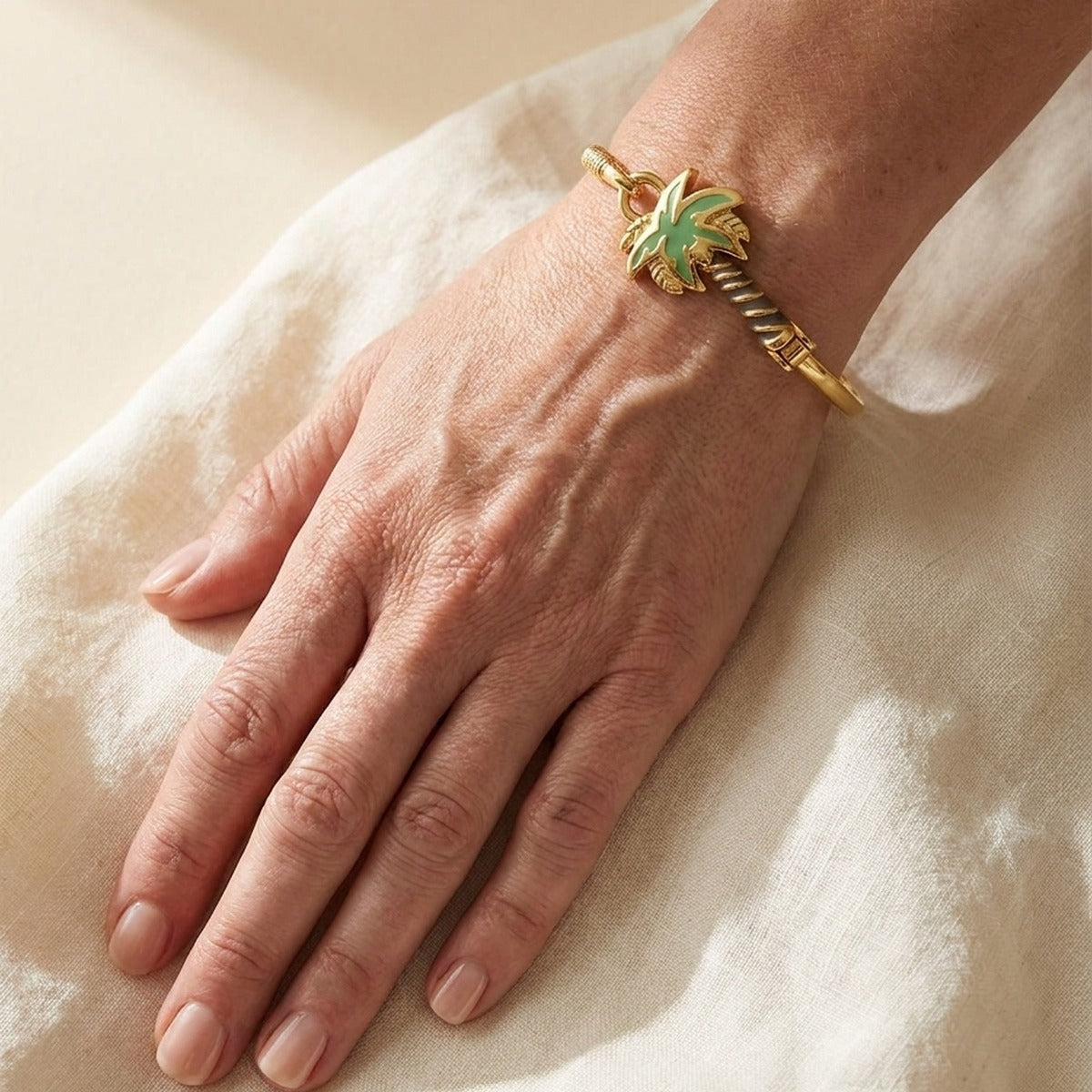 Eau Palm Tree Bangle with bold hook clasp, gold-tone bracelet featuring a green palm charm on Tampa Home & Garden Store
